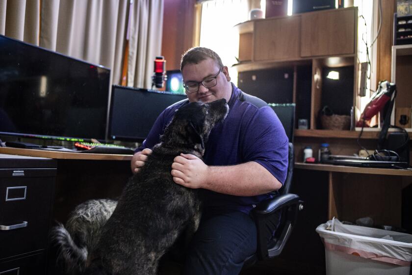IOWA CITY, IOWA JUNE 27, 2022 - Laurens van Beek with his dog Mocha at his family's home in Iowa City, Iowa on Monday, June 27, 2022. (Nick Rohlman / For The Times)
