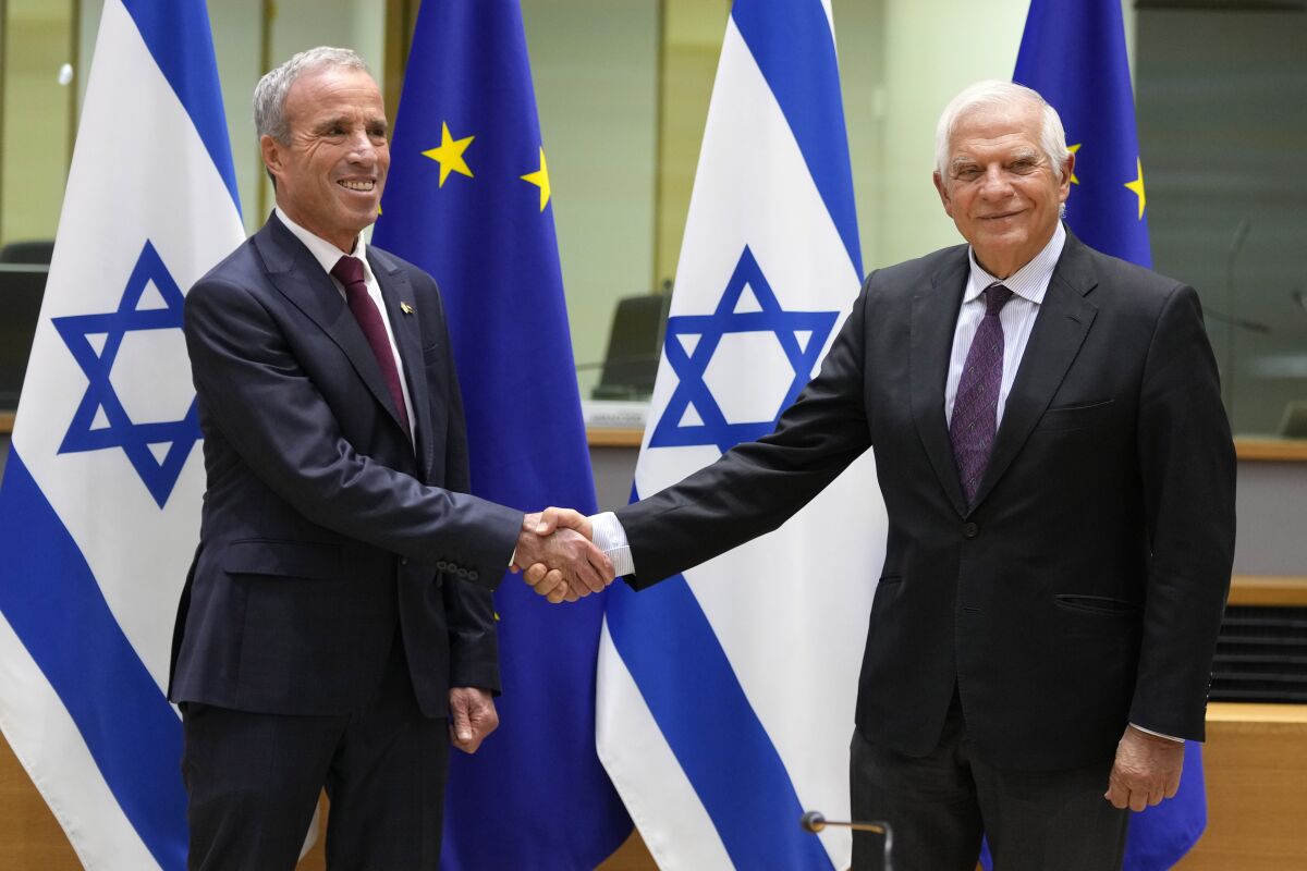 European Union foreign policy chief Josep Borrell, right, greets Israel's Minister of Intelligence Elazar Stern prior to a meeting of the EU-Israel Association Council at the EU Council building in Brussels on Monday, Oct. 3, 2022. (AP Photo/Virginia Mayo)