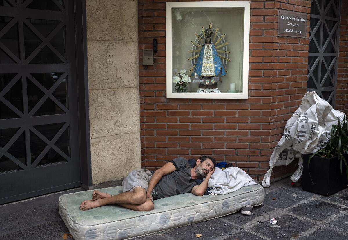 Agustín Catamano, de 48 años, quien dijo que no tiene hogar, duerme frente a una institución católica 