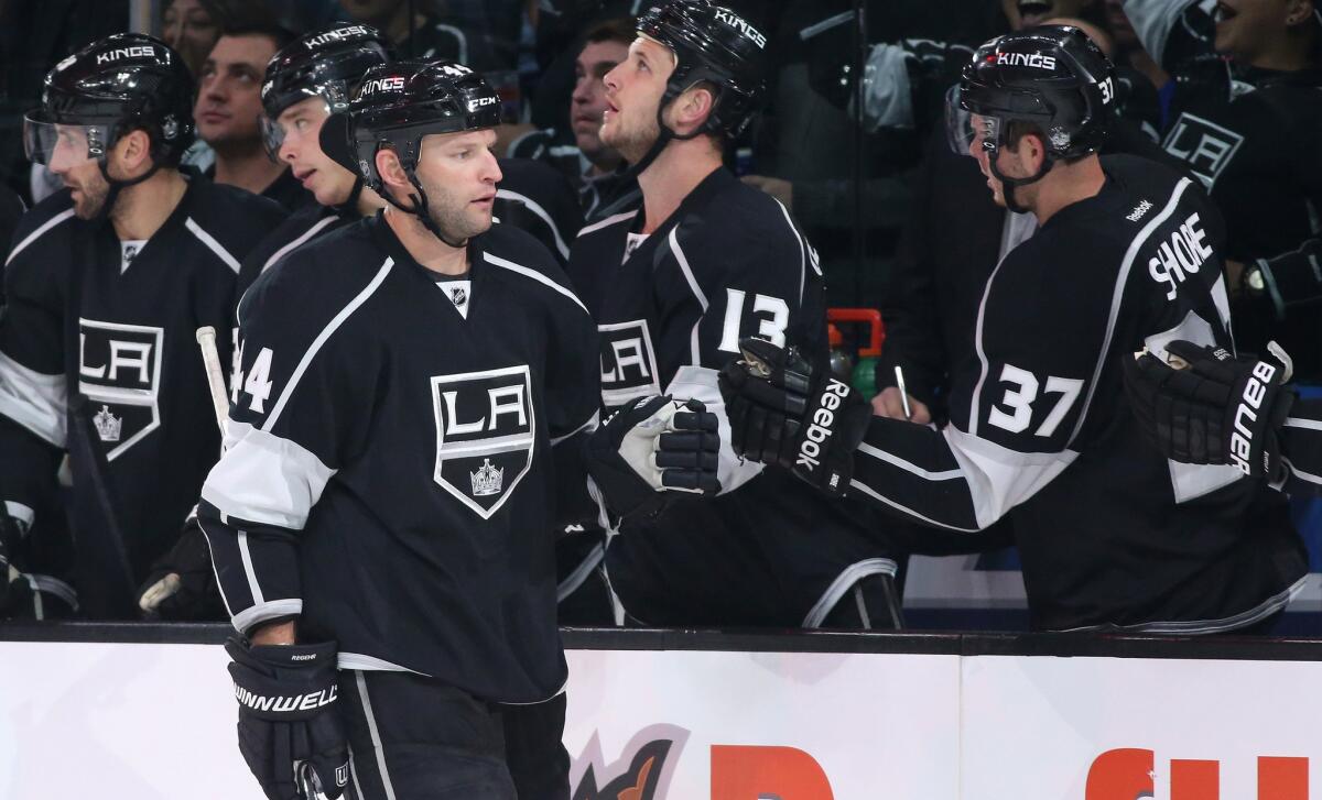 Kings defenseman Robyn Regehr is congratulated by teammates after assisting on a goal against the Avalanche in the first period Saturday night at Staples Center.