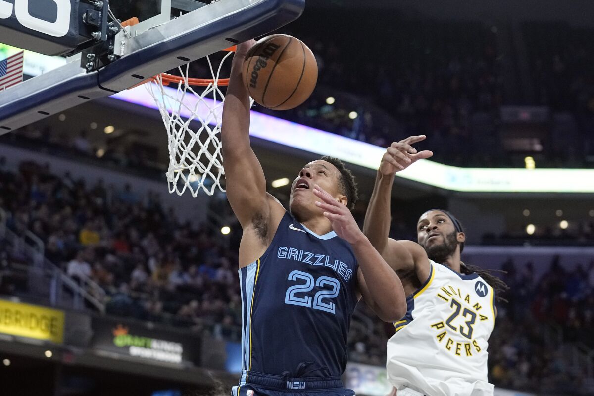 Memphis Grizzlies' Desmond Bane (22) puts up a shot against Indiana Pacers' Isaiah Jackson (23) during the second half of an NBA basketball game, Tuesday, March 15, 2022, in Indianapolis. (AP Photo/Darron Cummings)