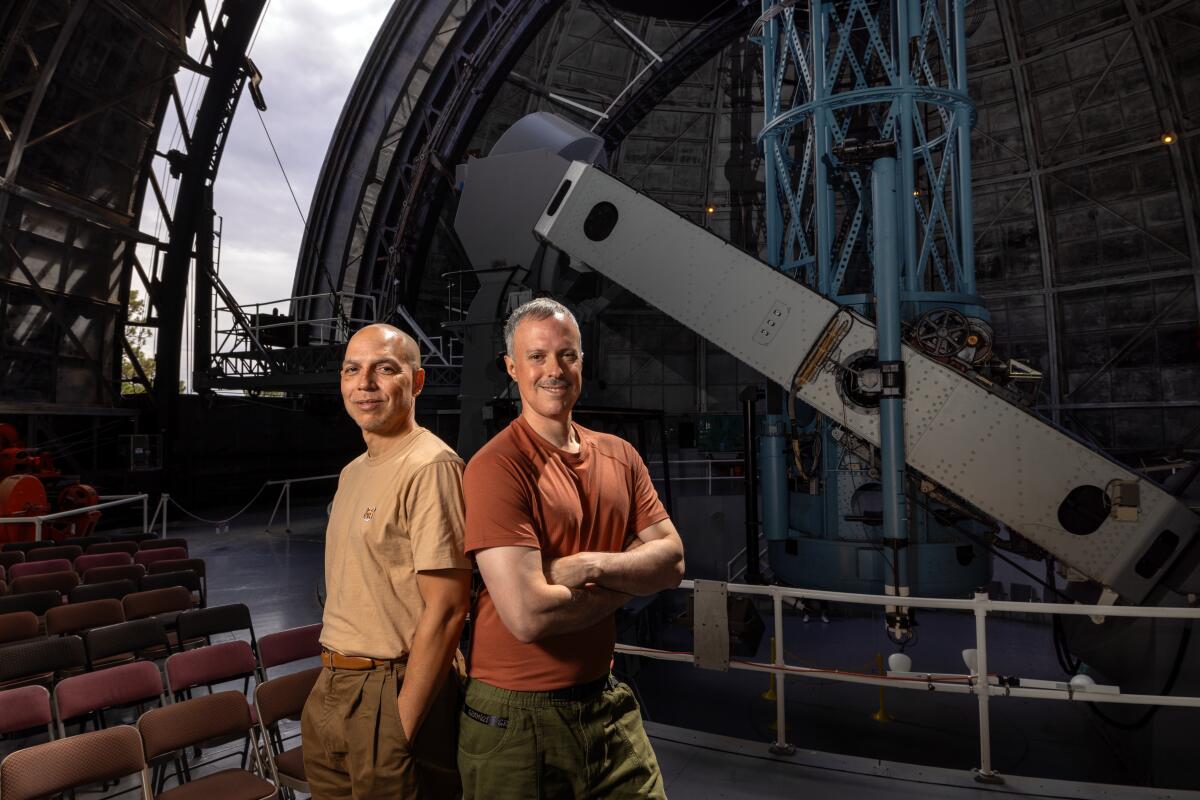 Two men standing at an observatory
