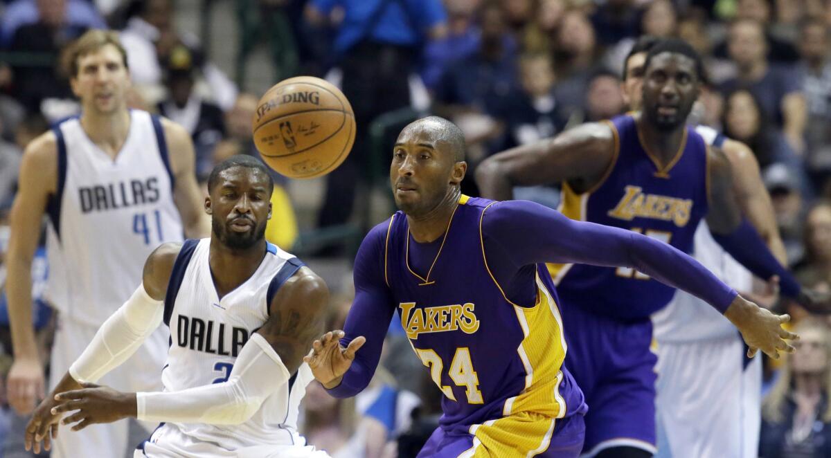 Kobe Bryant chases a loose ball in front of Dallas Mavericks guard Raymond Felton during the second half of a game on Nov. 13.