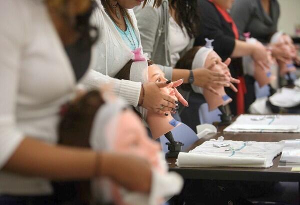 Students practice facial massage at Beatrice Santiago's Cosmetology class at the Santee Academy.