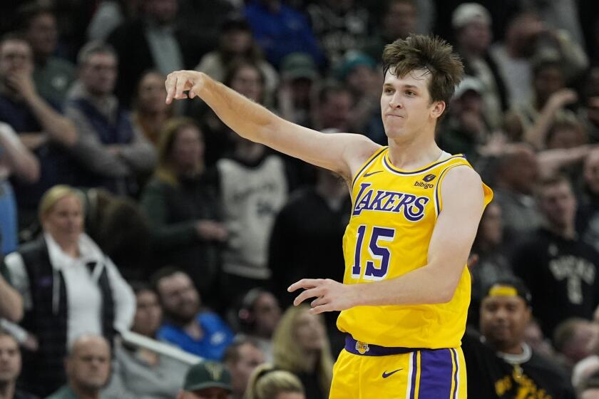 Laker Austin Reaves reacts after making a three pointer during the second overtime of the team's win over the Bucks