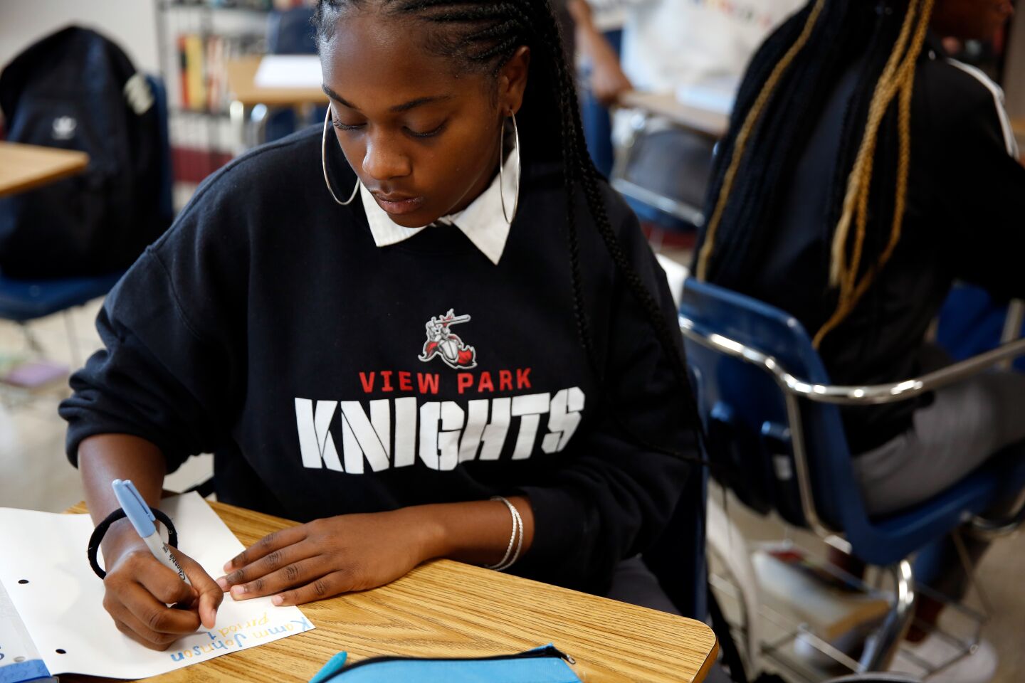 Kamryn Johnson takes notes during English class