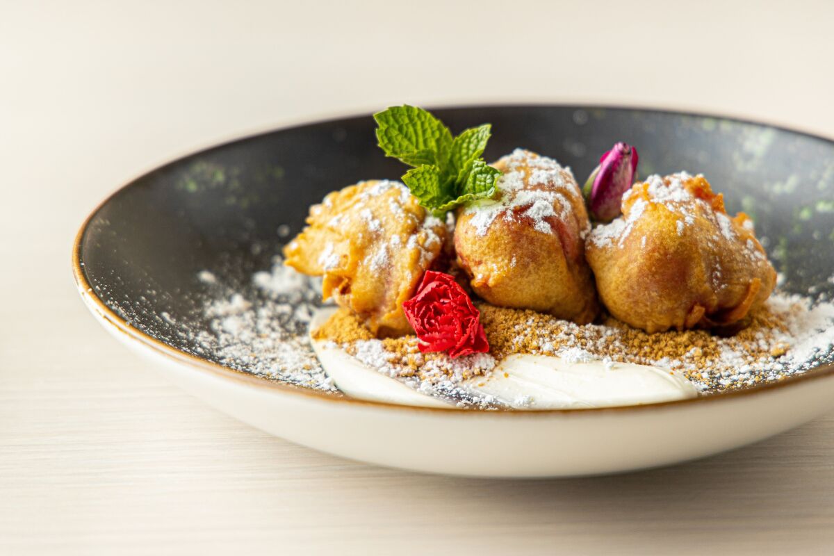Fried strawberries with whipped cheesecake, graham cracker crumb and whipped cream at 3rd Base in Hollywood