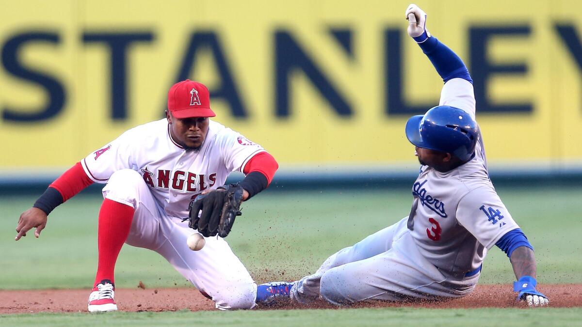 Dodgers left fielder Carl Crawford steals second base against shortstop Erick Aybar and the Angels on Monday night.