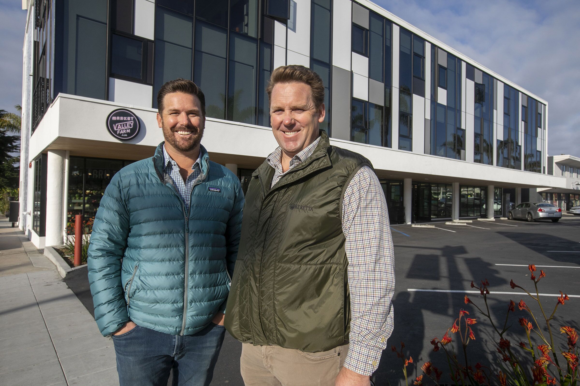 Developers Scott Murfey, right, and his brother Russ Murfey , left, outside of their recently completed Collins luxury apartment complex on La Jolla Boulevard.