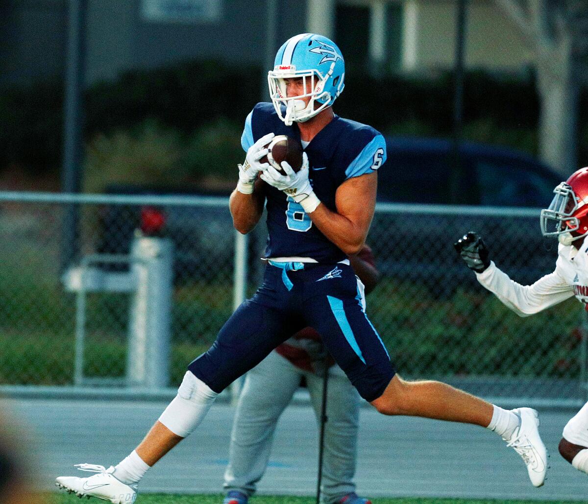 John Humphreys of Corona del Mar catches a nine-yard touchdown pass 70 seconds into Friday's nonleague game against Lakewood at Newport Harbor High.