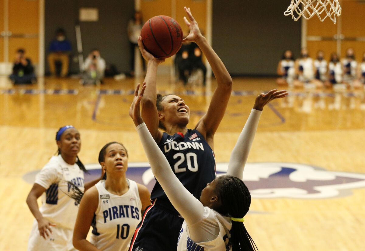 Connecticut forward Olivia Nelson-Ododa (20) drives to the basket against Seton Hall forward Kailah Harris (33) during the first half of an NCAA college basketball game on Friday, Dec. 3, 2021, in South Orange, N.J. (AP Photo/Noah K. Murray)
