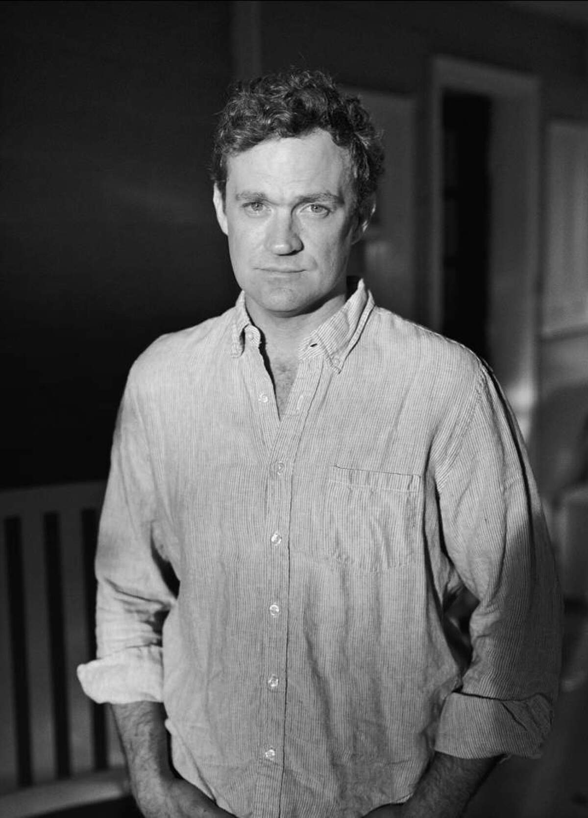 Patrick Radden Keefe, in a casual shirt, looks into the camera