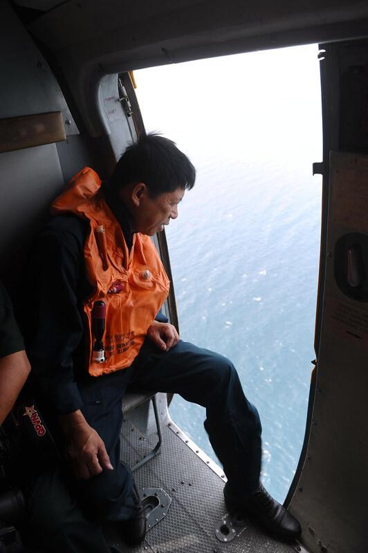 This picture taken aboard a Vietnamese Air Force's Russian-made MI-171 helicopter shows a crew member scanning the waters below during a search over the southern Vietnamese waters off Vietnam's island Phu Quoc on March 11.