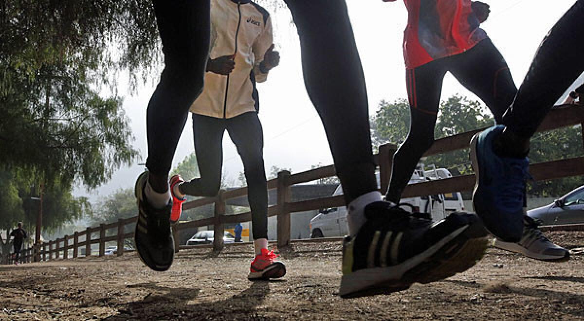 LA Marathon runners take a Friday morning training run in Griffith Park in Los Angeles.