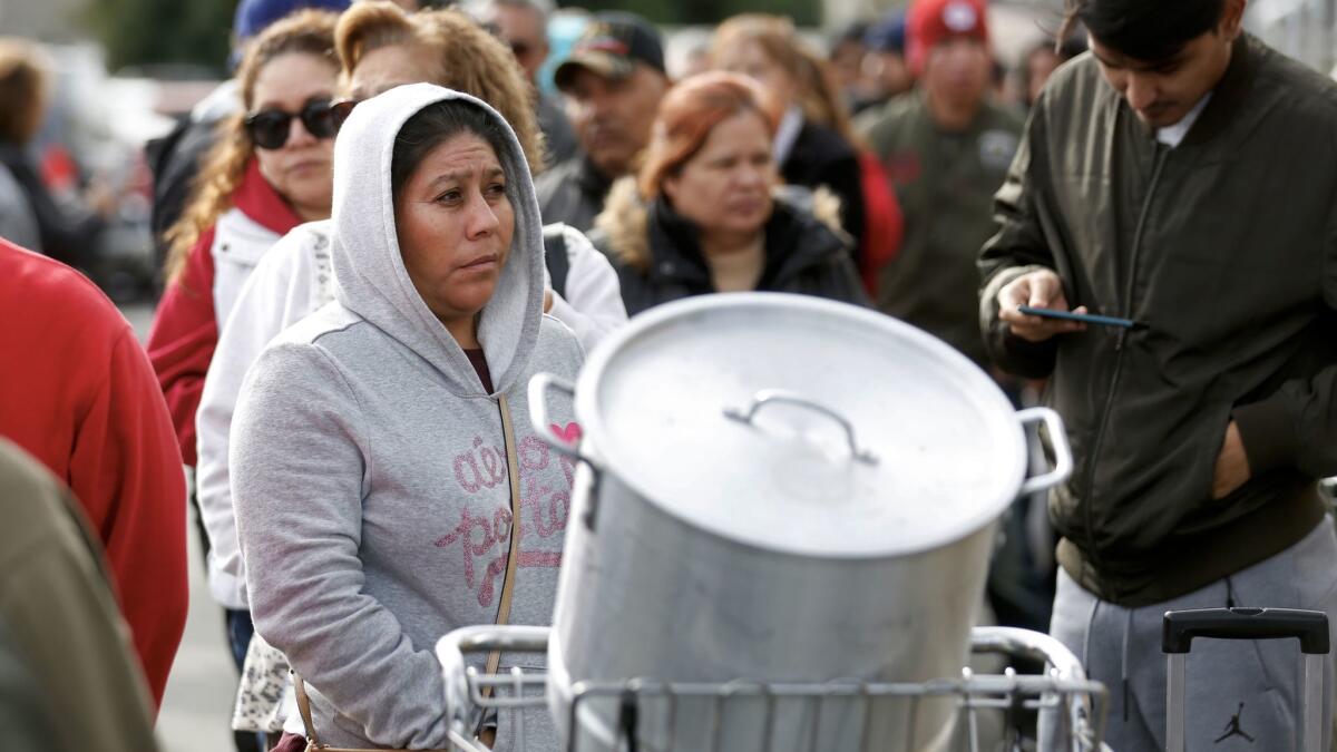 Customers wait in line as they seek refunds and explanations of why their tamales had gone bad, ruining their traditional Christmas meals.