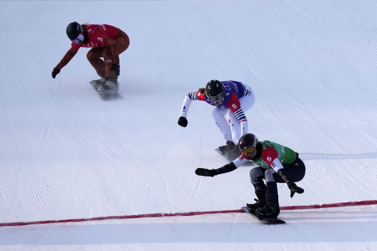 United States' Lindsey Jacobellis (5), followed by France's Chloe Trespeuch (8) and Canada's Meryeta O'Dine (3) crosses the finish line to win a gold medal during the women's cross final at the 2022 Winter Olympics, Wednesday, Feb. 9, 2022, in Zhangjiakou, China. (AP Photo/Lee Jin-man)