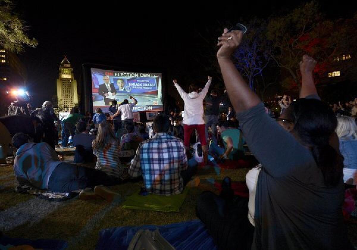 Supporters cheer as they watch CNN project the re-election of President Obama during "Park Your Politics" party at Grand Park in downtown Los Angeles.