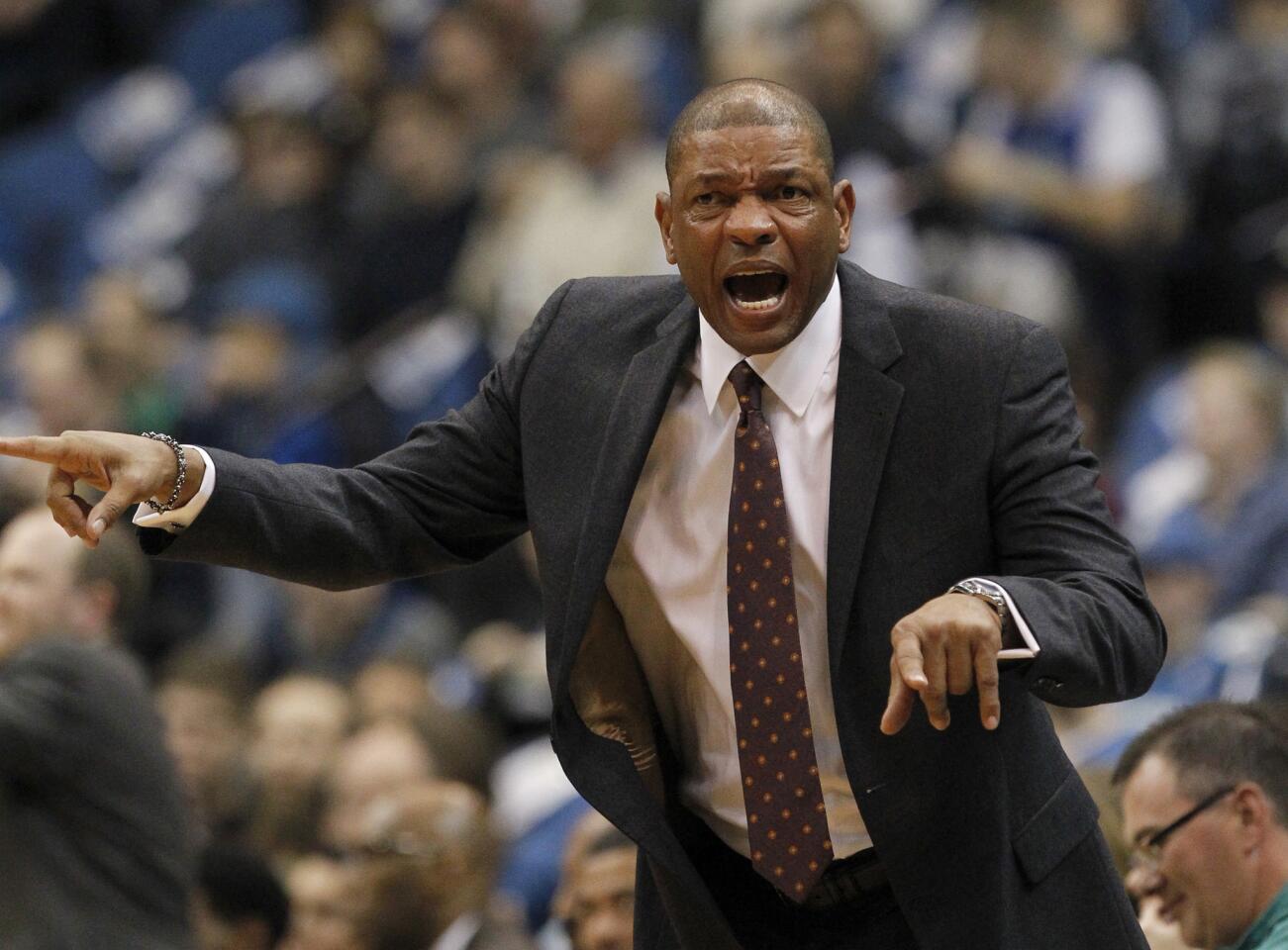 Clippers Coach Doc Rivers calls out to his players during the first half.