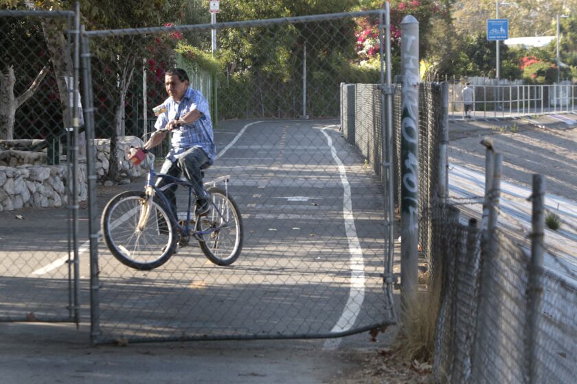 A bicycle rider turns off the bike path at its end at Egret Park in Los Angeles in June 2014.