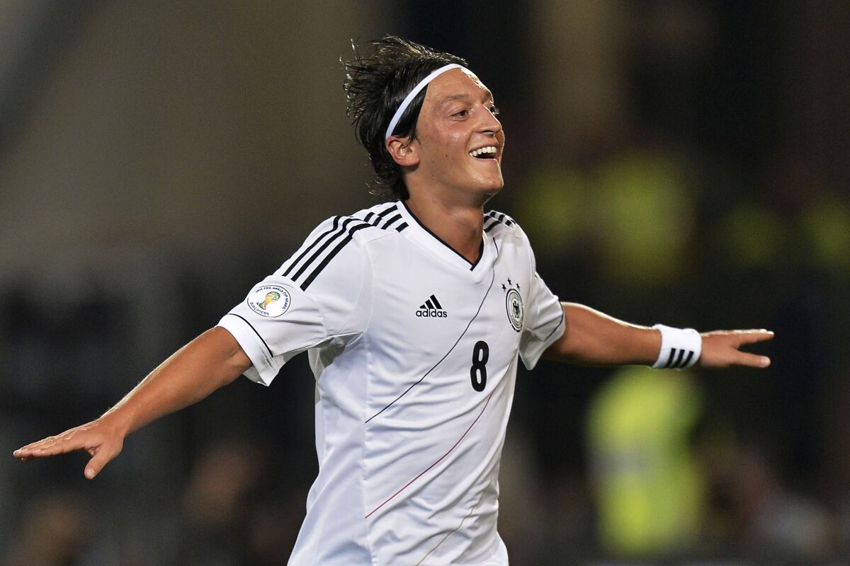 FILE - In this Sept. 7, 2012, file photo, Germany's man of the match Mesut Oezil celebrates after scoring during the Brazil World Cup 2014 group C qualifying soccer match between Germany and Faroe Islands in Hannover, Germany. Former Germany midfielder Mesut Özil, who won the World Cup in 2014, retired from soccer Wednesday, March 22, 2023, at the age of 34. (AP Photo/Martin Meissner, File)