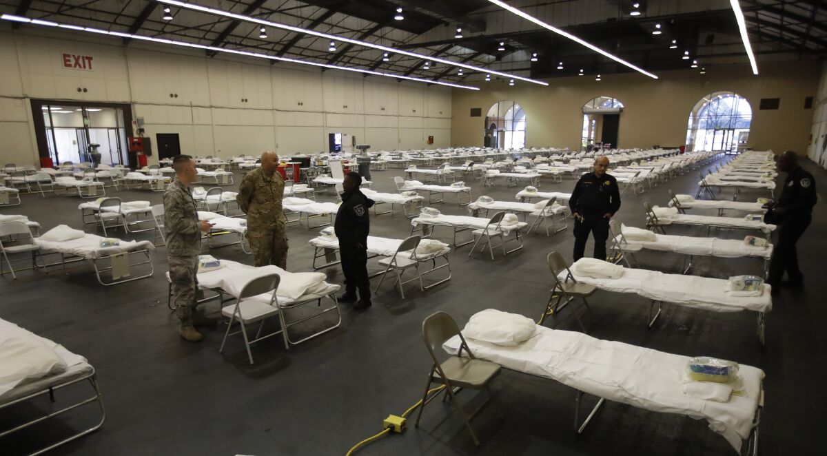 Cots are set up at a possible COVID-19 coronavirus treatment site Wednesday in San Mateo, Calif.