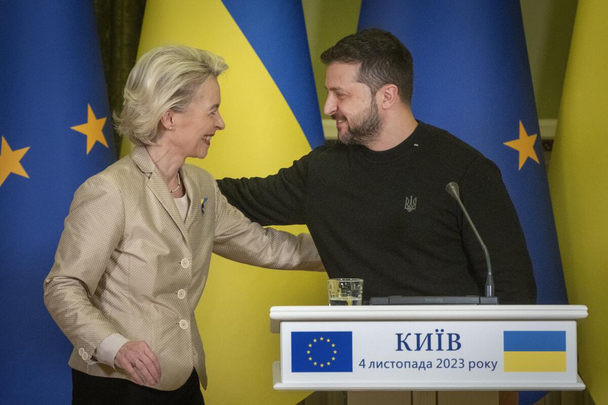 Ukrainian President Volodymyr Zelensky, right, greets European Commission President Ursula von der Leyen.