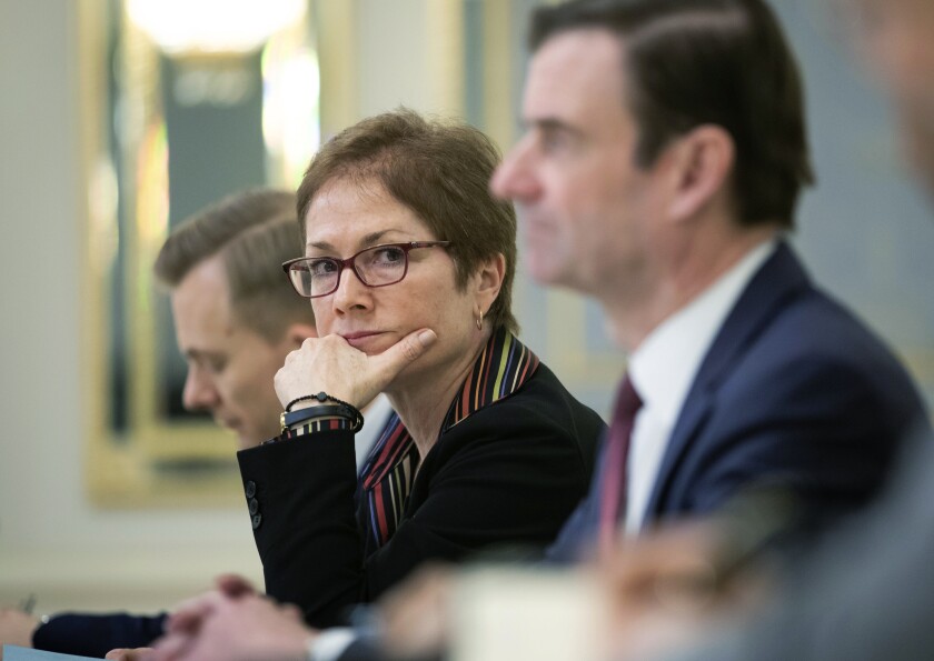 Marie Yovanovitch, former U.S. ambassador to Ukraine, sits beside then-Ukrainian President Petro Poroshenko in Kyiv, Ukraine, on March 6.