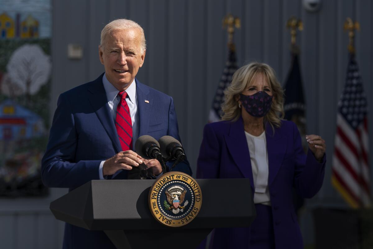 President Biden at a lectern with First Lady Jill Biden nearby