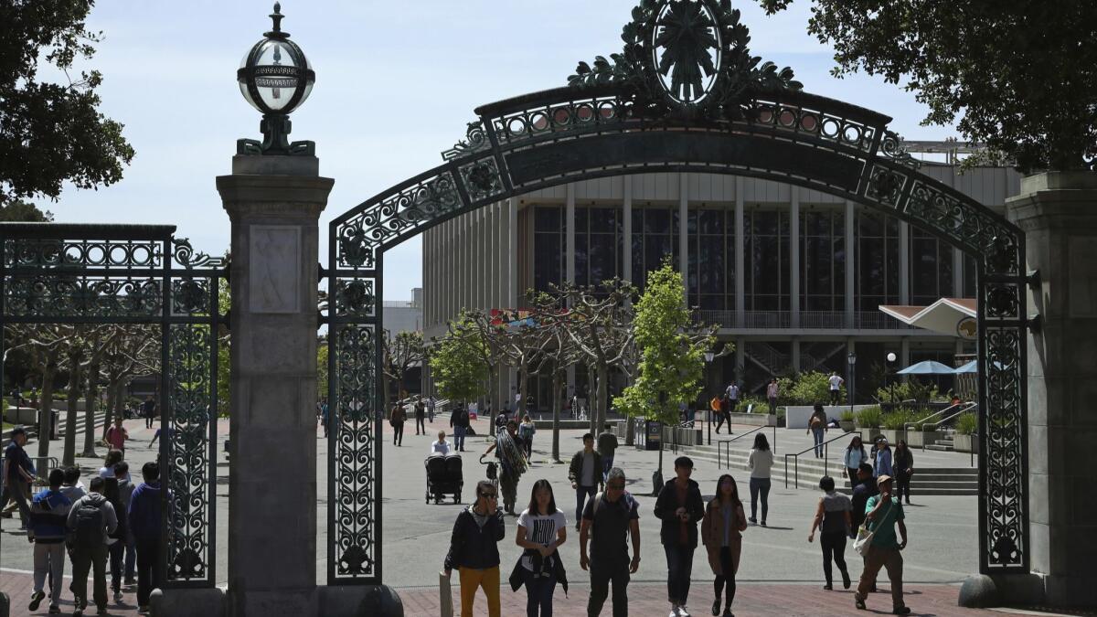 Students walk past Sather Gate on the UC Berkeley campus. Co-signing a student loan brings particular perils.