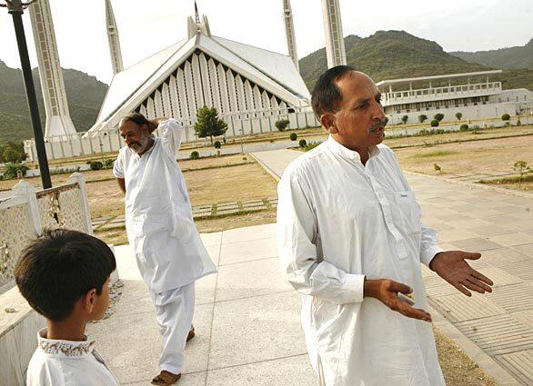 Khalid Mehmood, right, says he was encouraged by President Obama's speech but that it will have to be followed up by action. Mehmood and relatives Muhammed Ahsan, center, and Ahmad, 9, left, were visiting Faisal Mosque in Islamabad, Pakistan.