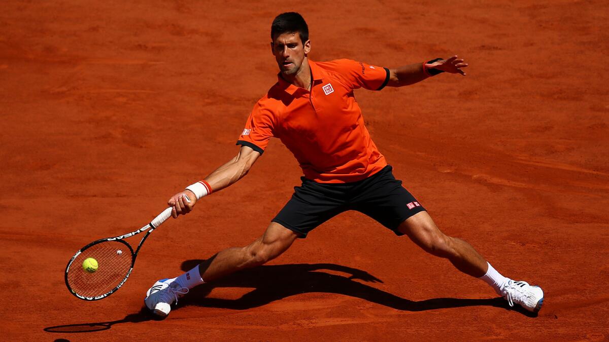 Novak Djokovic hits a return during his semifinal victory over Andy Murray at the French Open on Saturday.