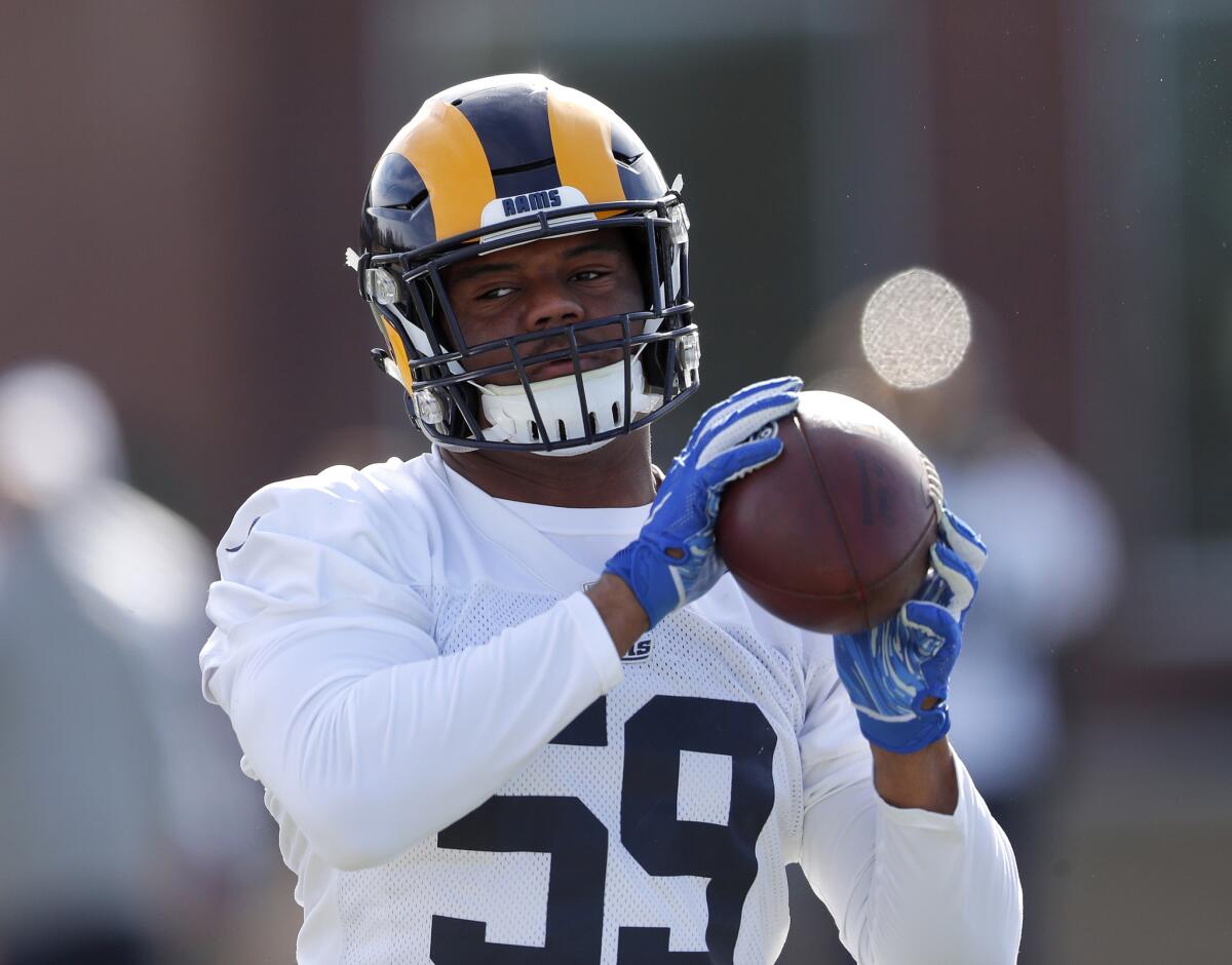 Rams linebacker Micah Kiser catches the football during practice.