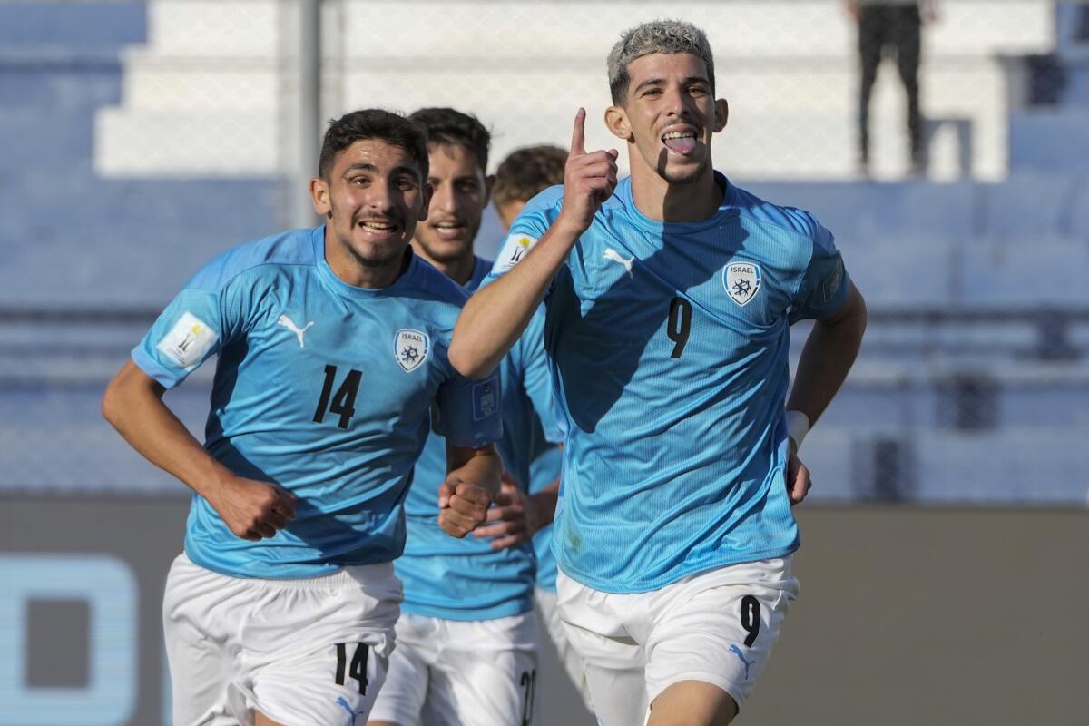 Israel's Dor Turgeman, right, celebrates with teammates after scoring his side's third goal during the extra time of a FIFA U-20 World Cup quarterfinal soccer match against Brazil at the Bicentenario stadium in San Juan, Argentina, Saturday, June 3, 2023. (AP Photo/Ricardo Mazalan)