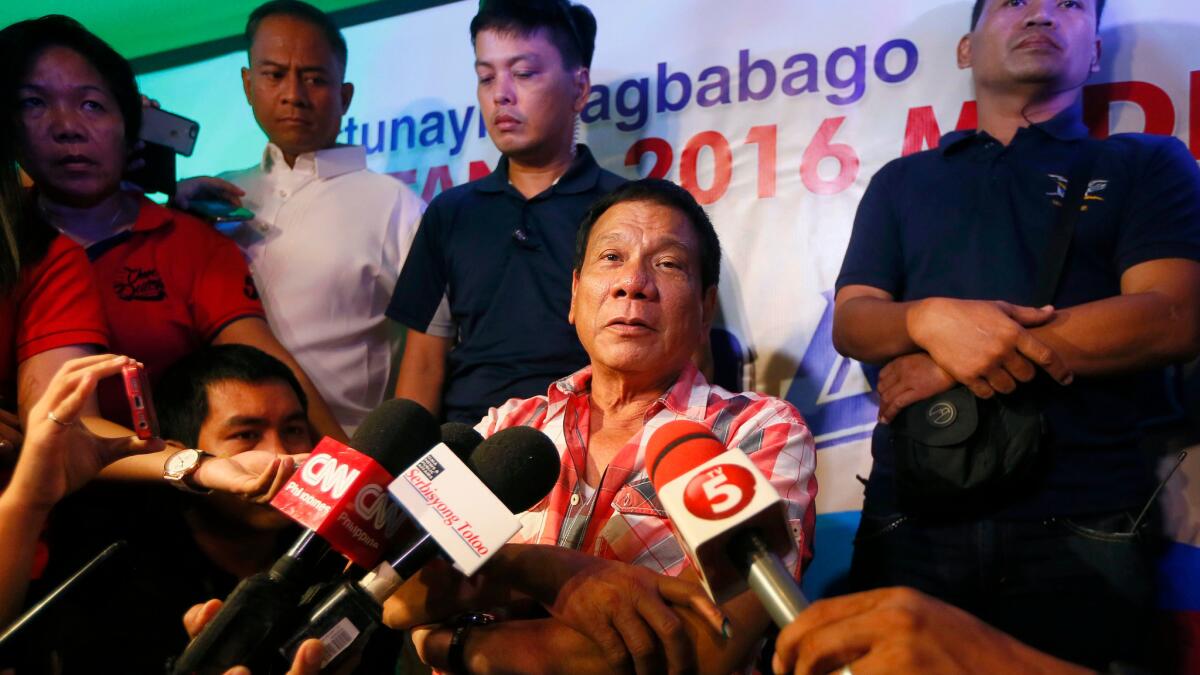 Philippine president-elect Rodrigo Duterte is interviewed by the media shortly after voting in a polling precinct during the May 9 election.