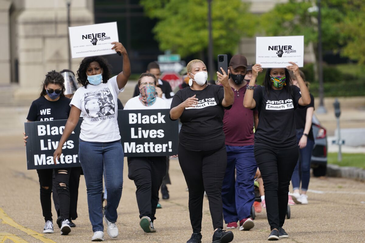 Family and foundation members participate in a march outside the Capitol in Jackson, Miss., Saturday, Aug. 29, 2020, commemorating the legacy of Emmett Till, a Black teenager who was killed in Money, Miss., 65 years ago for allegedly whistling at Carolyn Bryant, the wife of a white store owner in the town. The teenager was kidnapped from his great uncle's home and was later found dead in the Tallahatchie River. The violent nature of his death and subsequent public display of his body at his funeral helped galvanized the Civil Rights movement. (AP Photo/Rogelio V. Solis)