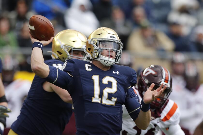 Notre Dame quarterback Ian Book (12) throws during the first half of an NCAA college football game, Saturday, Nov. 2, 2019, in South Bend, Ind. (AP Photo/Carlos Osorio)