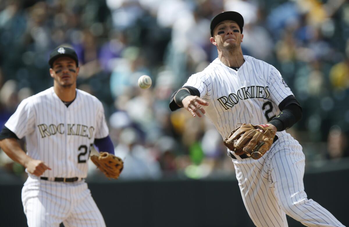 Rockies shortstop Troy Tulowitzki throws to first base, where San Diego outfielder Wil Myers is called out during a game on April 23.