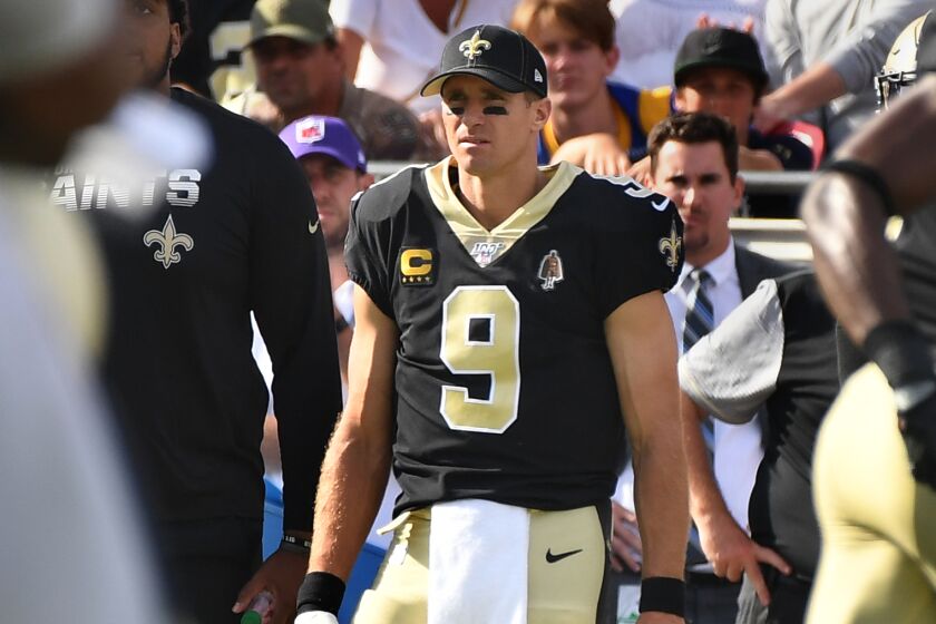 LOS ANGELES, CALIFORNIA SEPTEMBER 15, 2019-With his hand wrapped, Saints quarterback Drew Brees watches from the sideline at the Coliseum Sunday. (Wally Skalij/Los Angeles Times)