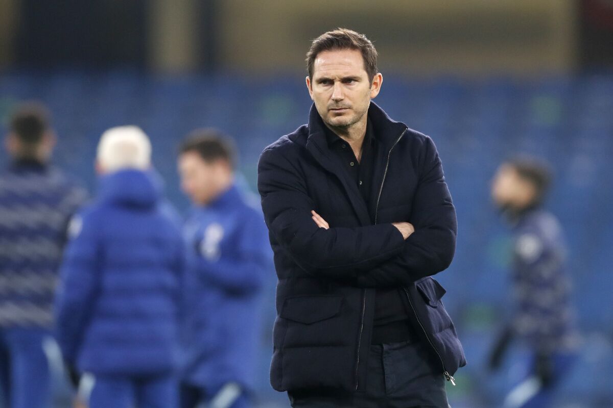 Chelsea's head coach Frank Lampard watches the players during warmup before the English Premier League soccer match between Chelsea and Tottenham Hotspur at Stamford Bridge in London, England, Sunday, Nov. 29, 2020. (Matthew Childs/Pool via AP)