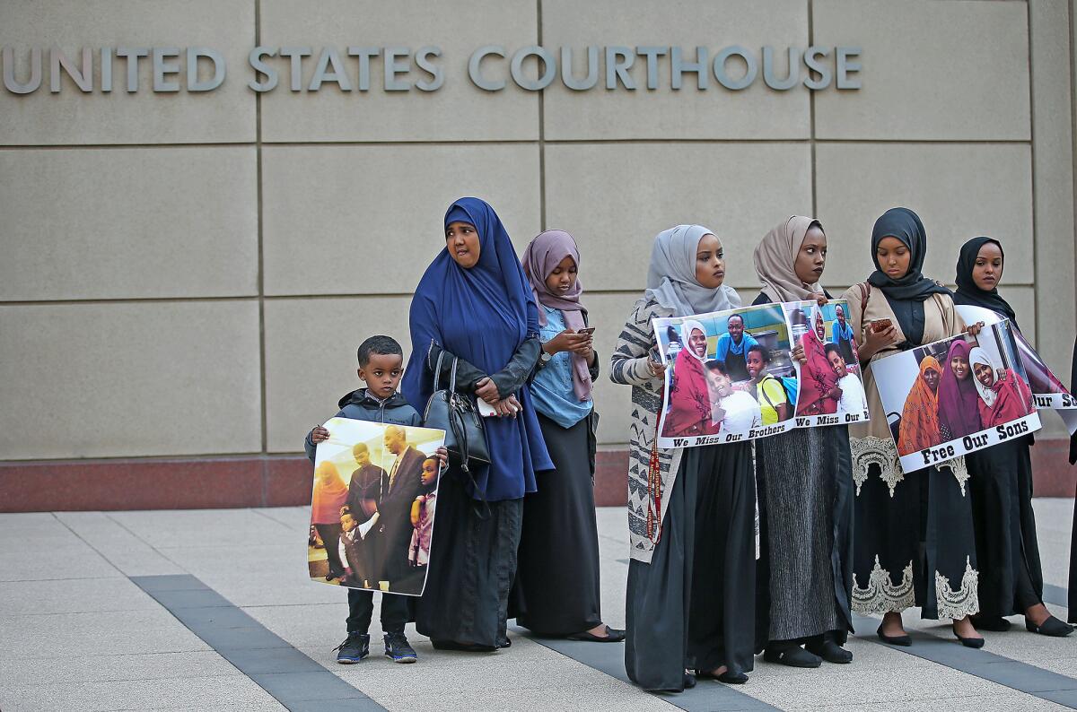 Supporters and family members of three men on trial rally outside the U.S. Courthouse in Minneapolis.