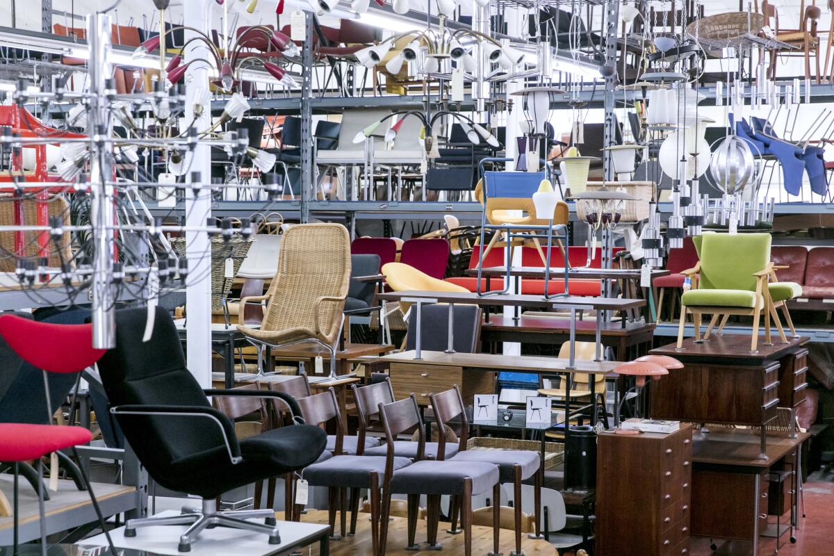 Organized and dense piles of tables and chairs fill the interior of furniture store Amsterdam Modern on Glendale Boulevard in downtown Los Angeles.