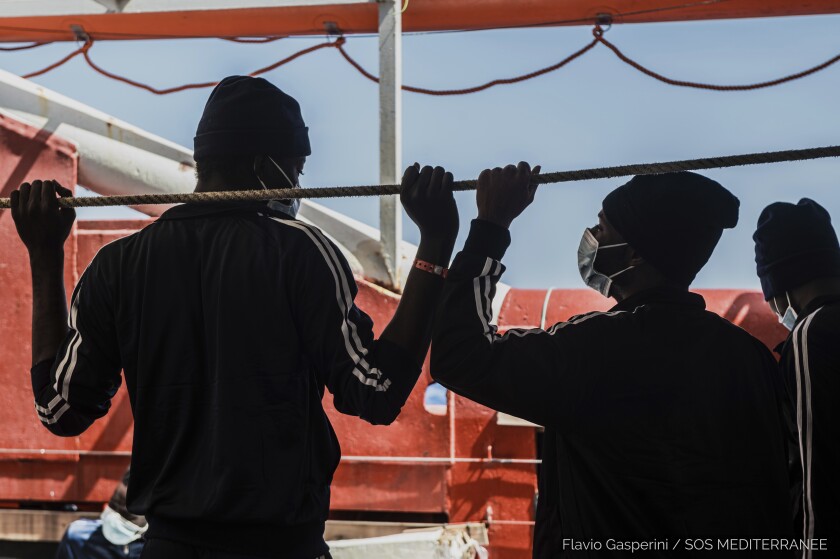 In this photo taken Thursday, April 29, 2021 migrants look at the sea from aboard the Ocean Viking during its navigation in the Mediterranean Sea. SOS Mediterranee said Saturday May 1, 2021 the Ocean Viking was sailing toward a Sicilian port with 236 migrants who were rescued days earlier in the Mediterranean from human traffickers' boats, while separately, Italy's coast guard and border police vessels brought 532 migrants rescued during the night to a tiny Italian island. (Flavio Gasperini/SOS Mediterranee via AP)