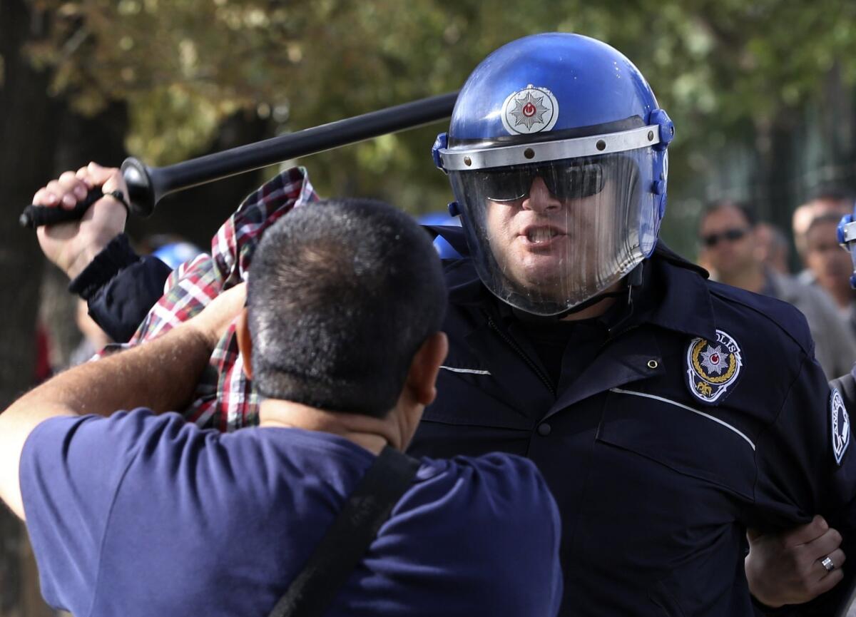 Turkish police officers in riot gear disperse protesters who tried to reach the site of Saturday's explosions to hold a memorial for the victims in Ankara, Turkey, on Oct. 11, 2015.