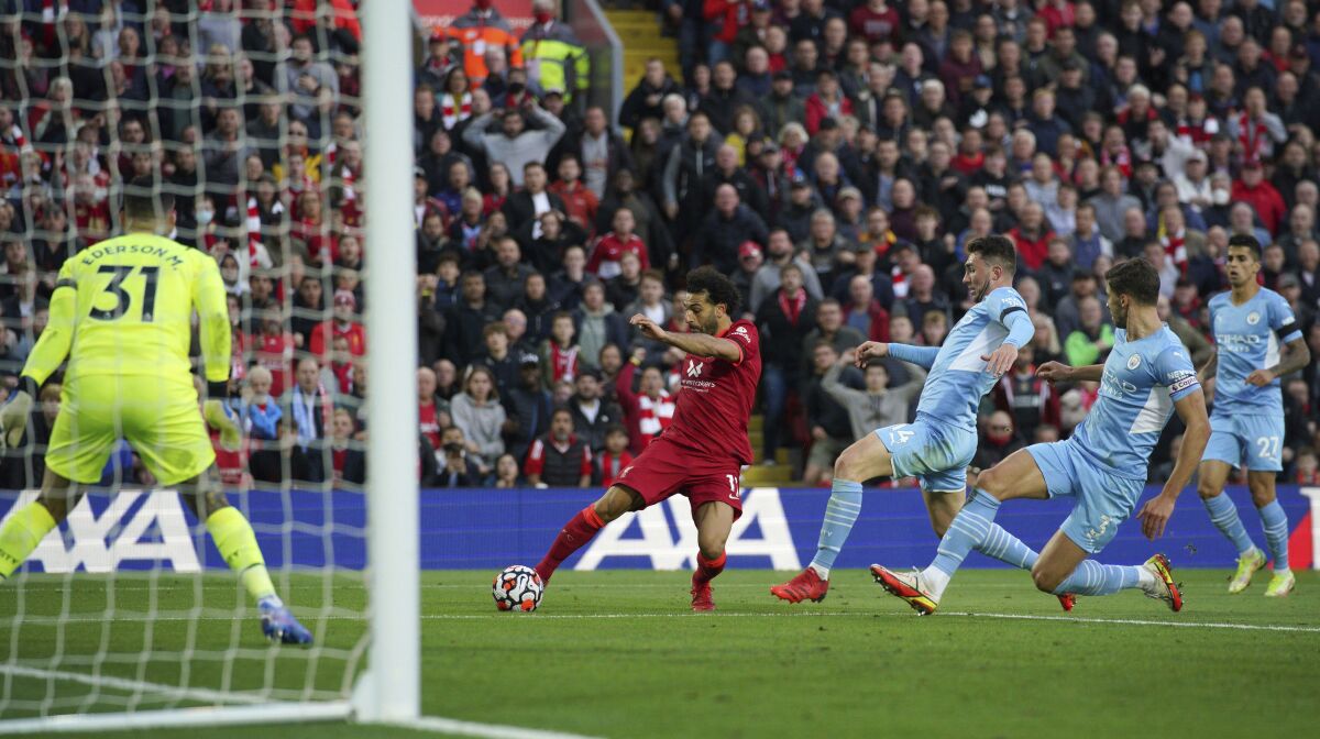 Liverpool's Mohamed Salah scores his side's second goal during the English Premier League soccer match between Liverpool and Manchester City at Anfield, Liverpool, England, Sunday Oct. 3, 2021. (Peter Byrne/PA via AP)
