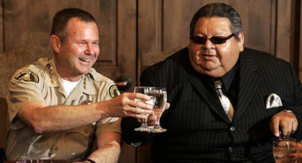 Riverside County Sheriff Stanley Sniff, left, and Robert Salgado, chairman of the Soboba Tribal Council, raise their glasses for a toast Monday.