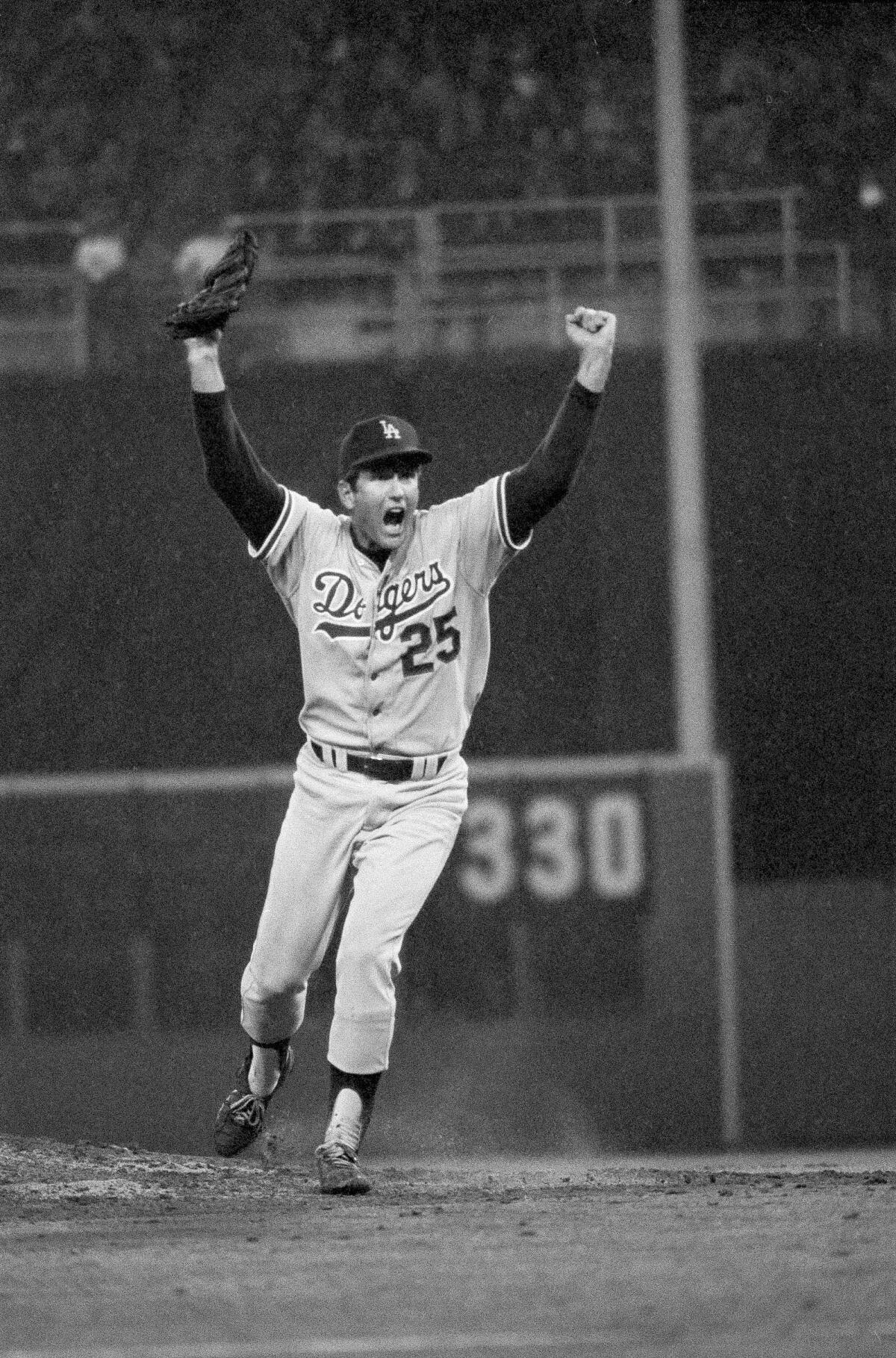 Dodgers pitcher Tommy John yells as he charges off the mound after a 4-1 playoff win over the Phillies in 1977.