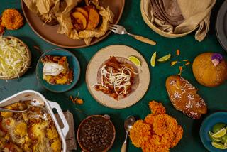 LONG BEACH, CA - OCTOBER 4: a spread of traditional Mexican dishes including Mixiote and Capirotada with Pan de Muerto and Marigold flowers that go on an ofrenda for Dia de Muertos on Friday October 4, 2024 in Long Beach, CA. (Ron De Angelis / For The Times)