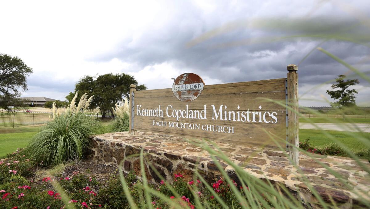 A sign marks the entrance of the Kenneth Copeland Ministries Eagle Mountain Church, which is linked to at least 21 cases of measles and has been trying to contain the outbreak by hosting vaccination clinics, officials said.