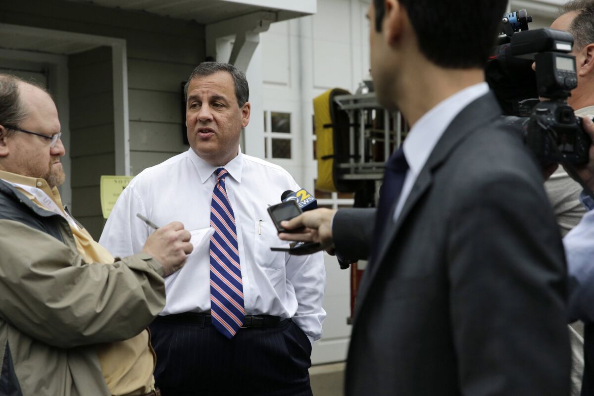 New Jersey Gov. Chris Christie, center, stops to answer questions after he voted on June 2 in Mendham Township, N.J.