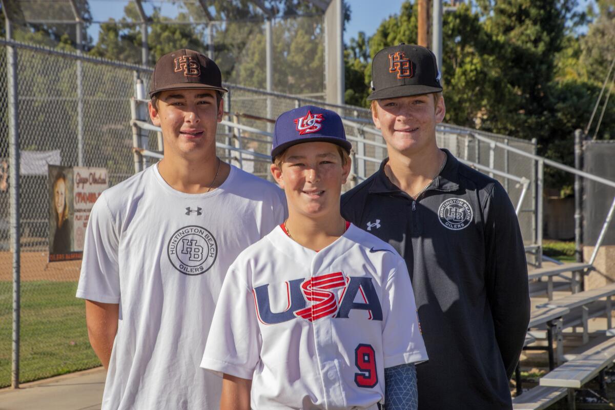 Team USA 12-and-under member Jared Grindlinger, 12, with Huntington Beach High School brothers Brad, 16, left, and Trent, 15.
